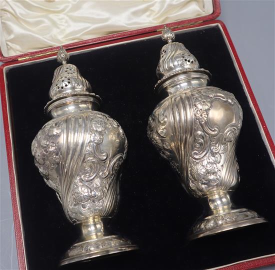 A cased pair of late Victorian silver sugar casters, Daniel & John Welby, London, 1897, 14.5 oz.